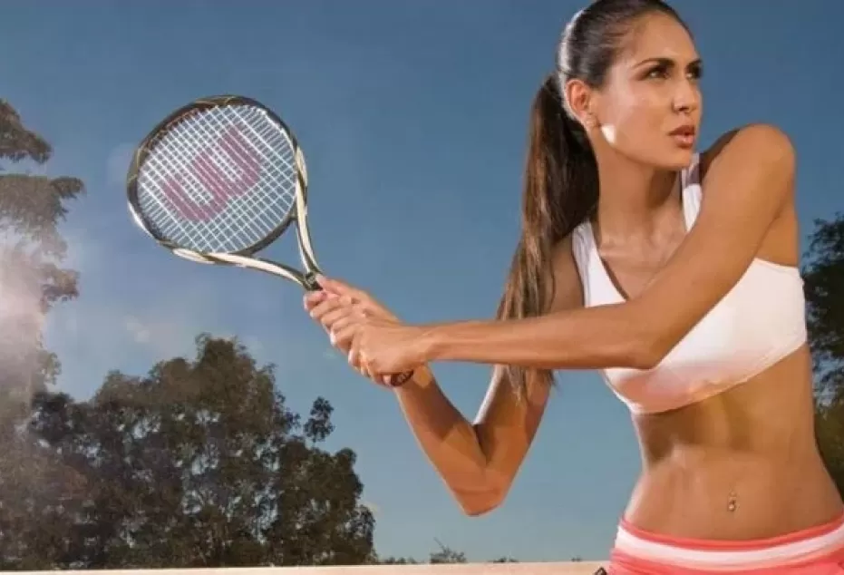 Claudia Lampe jugando al tenis durante una sesión de fotos.