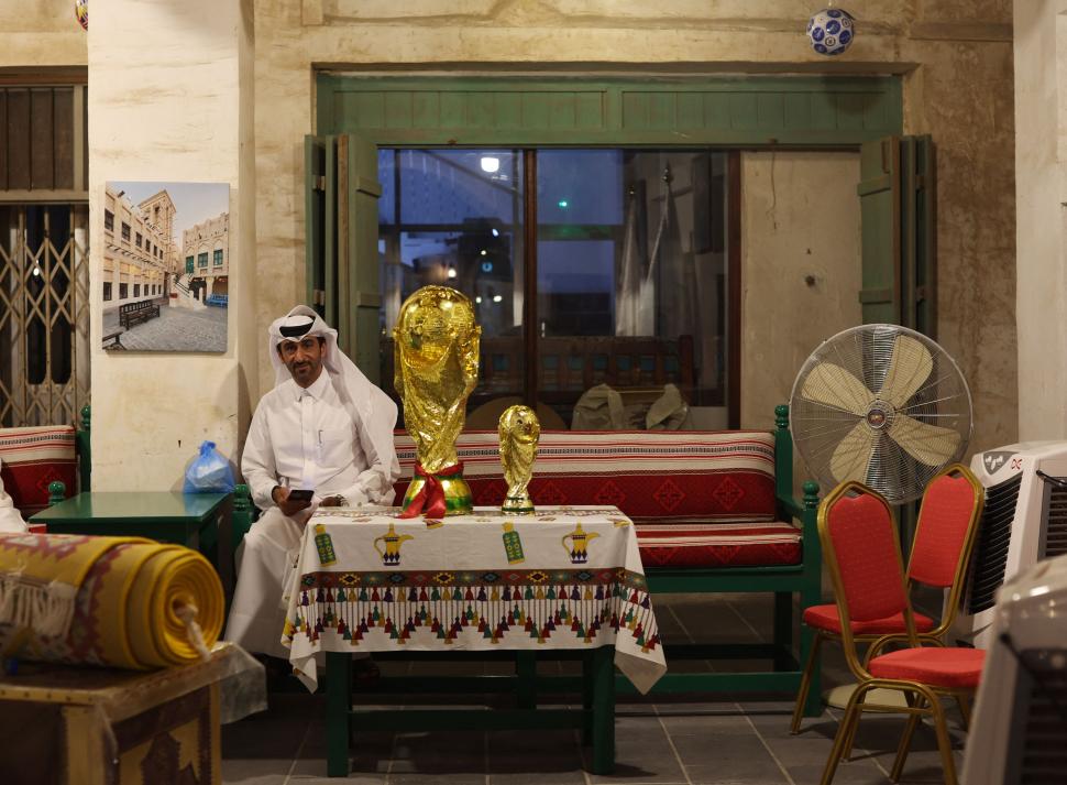 RECUERDO. Un qatarí posa con las réplicas de la Copa.