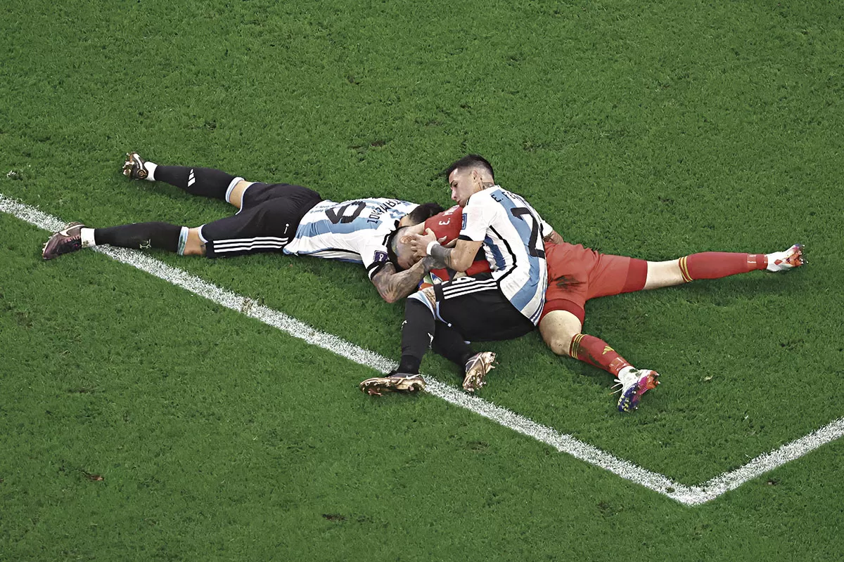 ¡GRACIAS, “DIBU”! Otamendi y Enzo Fernández abrazan a Emiliano Martínez después del atajadón que evitó el empate en la última jugada. Una intervención crucial del arquero, que se festejó como un gol.