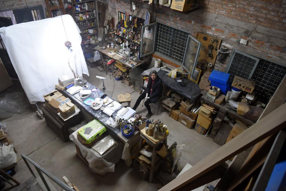 PANORÁMICA. El taller de restauración con sus diversas herramientas. En algunos rincones sobrecargados aparecen estampitas y esculturas sin acabar. 