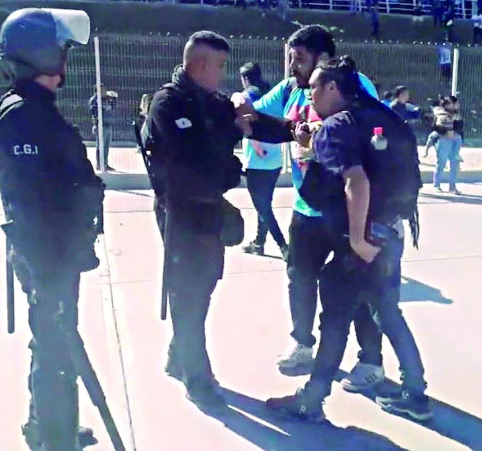 LAMENTABLE. El periodista Daniel Coronel trata de impedir la detención de su compañero, el fotógrafo Franco Vera.  captura de video