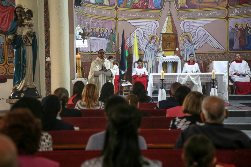 EN GAZA. Cristianos palestinos celebran la misa del Domingo de Pascua en la iglesia de la Sagrada Familia.