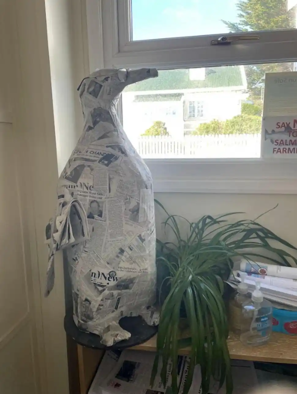 un “pingüino” forrado con páginas del semanario da la bienvenida a la sala de redacción.