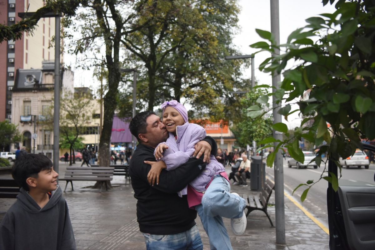 ELLA Y SU TÍO. Con turbante lila, una sonrisa y toda su familia detrás, Valentina celebró el final de la quimioterapia. / LA GACETA, ANALÍA JARAMILLO